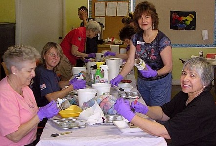 Shibori workshop: women in purple gloves